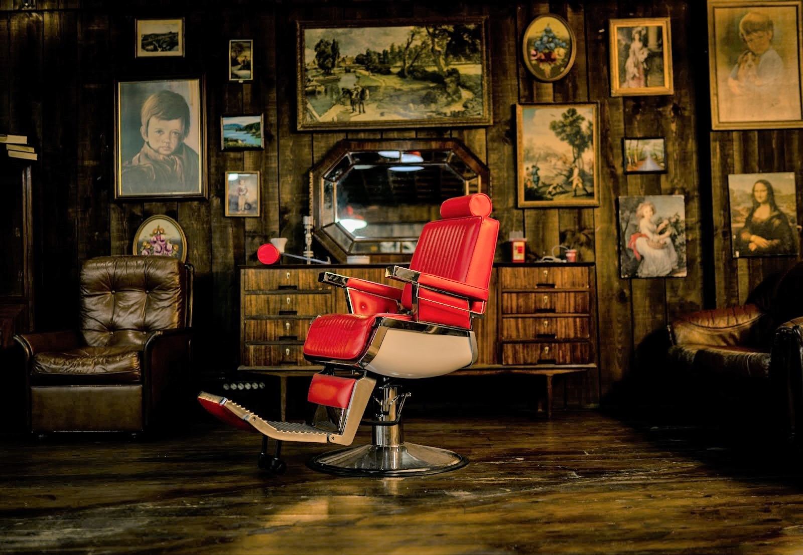 traditional barbershop with paintings on the wall and red barber chair